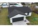Aerial shot of the home's exterior with a dark grey roof and paved driveway at 6 Bahia Course Ln, Ocala, FL 34472
