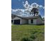 Well-manicured lawn in front of this charming one-story home with a dark gray garage door at 6 Bahia Course Ln, Ocala, FL 34472