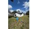 Exterior shot of home and backyard with water well and spacious lawn at 6 Bahia Course Ln, Ocala, FL 34472