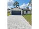 Charming single-story home featuring a gray driveway, two-car garage, and a well-manicured lawn at 6 Bahia Course Ln, Ocala, FL 34472