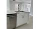 Modern kitchen island features stainless steel appliances, a double sink, and white cabinetry at 6 Bahia Course Ln, Ocala, FL 34472