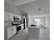 Modern kitchen features stainless steel appliances, white cabinets, an island and a sliding glass door to the backyard at 6 Bahia Course Ln, Ocala, FL 34472