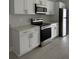 Close up of a modern kitchen featuring stainless steel appliances and white cabinets at 6 Bahia Course Ln, Ocala, FL 34472