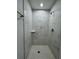 Beautiful shower with marble tiling and overhead shower fixture at 6 Bahia Course Ln, Ocala, FL 34472