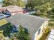 Aerial view of a single-story home with a weathered roof, a small front porch and mature landscape around property at 615 N Emory Ave, Kissimmee, FL 34741