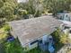 An aerial view of a well-kept home with a tidy lawn and surrounding lush trees offering a peaceful setting at 615 N Emory Ave, Kissimmee, FL 34741