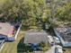 Aerial view of a single Gathering home with a large, fenced backyard with mature trees, providing privacy and space at 615 N Emory Ave, Kissimmee, FL 34741