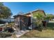Backyard area with screened-in patio and steps leading to yard at 615 N Emory Ave, Kissimmee, FL 34741