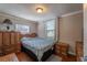Cozy bedroom with hardwood floors, neutral walls, and natural light at 615 N Emory Ave, Kissimmee, FL 34741