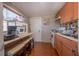 A cozy kitchen featuring a countertop seating area, compact appliances and wood-style flooring at 615 N Emory Ave, Kissimmee, FL 34741