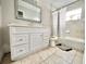Neutral bathroom with a single vanity and a tub/shower combo at 616 N Palm Ave, Kissimmee, FL 34741