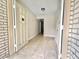 View of the bright entryway features neutral tile flooring, a white front door, and access to other rooms at 616 N Palm Ave, Kissimmee, FL 34741