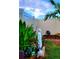 Landscaped backyard featuring a statue, colorful flowers, and privacy fence at 676 Tanaro Ln, Haines City, FL 33844