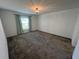 Bedroom with neutral carpet, a window with curtains, and contemporary ceiling lighting at 676 Tanaro Ln, Haines City, FL 33844