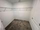 Walk-in closet featuring carpeted floors and a metal shelving unit at 676 Tanaro Ln, Haines City, FL 33844