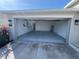 Spacious two car garage showing epoxy floor, water heater, and EV car charger at 676 Tanaro Ln, Haines City, FL 33844