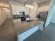 Modern kitchen featuring gray countertops, stainless steel appliances, and ample cabinet space at 676 Tanaro Ln, Haines City, FL 33844