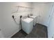 Functional laundry room featuring a washer, dryer, and storage shelving at 676 Tanaro Ln, Haines City, FL 33844