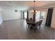Spacious living and dining area with tile floors and sliding glass doors at 676 Tanaro Ln, Haines City, FL 33844