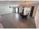 Open-concept living and dining area with tile floors and plenty of natural light at 676 Tanaro Ln, Haines City, FL 33844