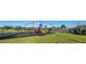 Community playground with swings, slides, and picnic tables at 676 Tanaro Ln, Haines City, FL 33844