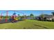 Community playground featuring a colorful play structure, and picnic tables at 676 Tanaro Ln, Haines City, FL 33844