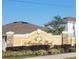 Magnolia Park sign with plants and stone pillars at 676 Tanaro Ln, Haines City, FL 33844