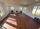 Bright sunroom with hardwood floors, many windows, and a charming fireplace at 676 Tanaro Ln, Haines City, FL 33844