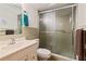 Clean bathroom featuring a shower with sliding glass doors, sink and a toilet at 706 Francis St, Kissimmee, FL 34741
