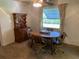 Cozy dining area includes a wooden hutch, matching dining table and seating for four at 706 Francis St, Kissimmee, FL 34741