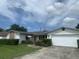 Charming single-story home features a brick accent, well-manicured lawn, and attached garage at 706 Francis St, Kissimmee, FL 34741