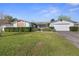 Single-story home features a brick accent, large front lawn and an attached two car garage at 706 Francis St, Kissimmee, FL 34741