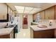 Functional kitchen with tile floor, countertop, cabinets, and modern appliances at 706 Francis St, Kissimmee, FL 34741