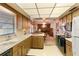 Cozy kitchen boasts wooden cabinetry and a view into the inviting living space at 706 Francis St, Kissimmee, FL 34741