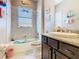 Whimsical bathroom featuring a tub, vanity, and playful decor at 741 Villa Park Rd, Poinciana, FL 34759