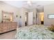 Cozy bedroom featuring a dresser with mirror, tile floor, and neutral walls at 741 Villa Park Rd, Poinciana, FL 34759