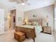 Relaxing bedroom with a patterned bedspread, tropical decor, and access to the ensuite bathroom and closet at 741 Villa Park Rd, Poinciana, FL 34759