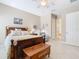 Comfortable bedroom boasts a wooden bed frame, coordinating furniture, and a serene, light-filled ambiance at 741 Villa Park Rd, Poinciana, FL 34759
