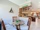 Charming dining area with a palm tree table, comfortable seating, and an open layout at 741 Villa Park Rd, Poinciana, FL 34759