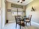 Cozy dining area featuring a round glass table, comfortable seating, and natural light at 741 Villa Park Rd, Poinciana, FL 34759