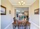 Dining room with tile flooring, traditional wood furniture, and a view into the kitchen and living area at 741 Villa Park Rd, Poinciana, FL 34759