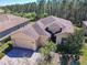 Inviting single-Gathering home featuring a well-manicured lawn, brick driveway, and a spacious three-car garage at 741 Villa Park Rd, Poinciana, FL 34759