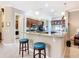 The kitchen has bar seating, modern appliances, and seamless flow into other living spaces at 741 Villa Park Rd, Poinciana, FL 34759