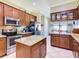 Modern kitchen with granite countertops, stainless steel appliances, and a stylish central island at 741 Villa Park Rd, Poinciana, FL 34759