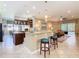 Open-concept kitchen with granite countertops, bar seating, and seamless flow into the living area at 741 Villa Park Rd, Poinciana, FL 34759