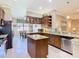 Well-appointed kitchen featuring granite countertops, an island, and modern stainless steel appliances at 741 Villa Park Rd, Poinciana, FL 34759