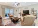 Bright living room with tile flooring, ceiling fan, and sliding glass doors to the outdoor space at 741 Villa Park Rd, Poinciana, FL 34759