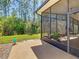 Side view of a large, screened in lanai with a view of the backyard at 741 Villa Park Rd, Poinciana, FL 34759