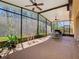 Spacious screened patio with ceiling fans, green view, and plenty of room for entertaining at 741 Villa Park Rd, Poinciana, FL 34759