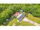 An aerial view showcases a cozy home with a pool, multiple outbuildings, and a huge lot lined with mature trees at 78 N 5Th St, Orlando, FL 32833